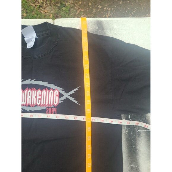 Vintage Y2K Jesus t-shirt in black with Awakening 2004 graphic and tape measuring its dimensions