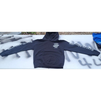 Black Harley Davidson hoodie with logo on chest and text on sleeves laid flat on surface