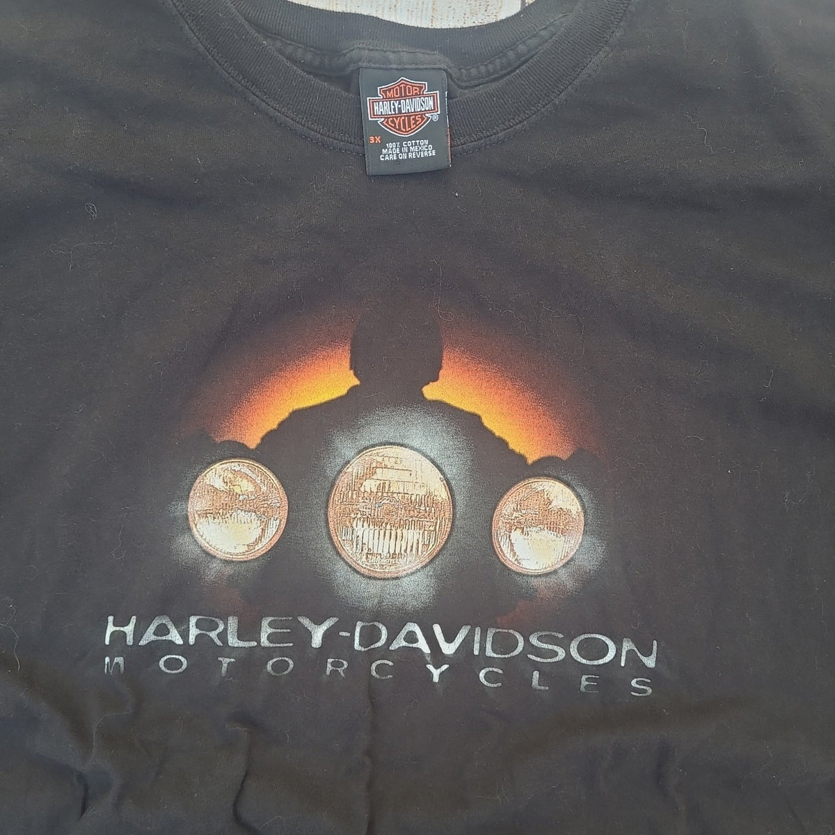 Black vintage Harley Davidson shirt featuring motorcycle headlights and Harley-Davidson logo