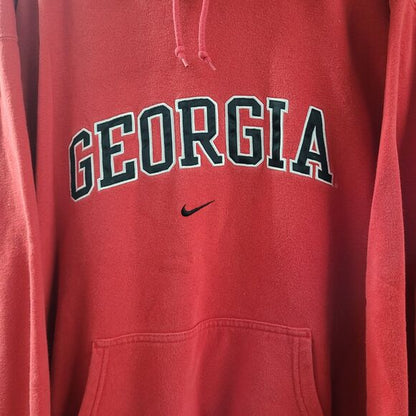Red center swoosh Nike Bulldogs hoodie with Georgia text and front pocket from RetroVintage Thrift