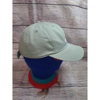 RetroVintage Thrift beige vintage 90s Nike snapback hat displayed on a colorful mannequin head