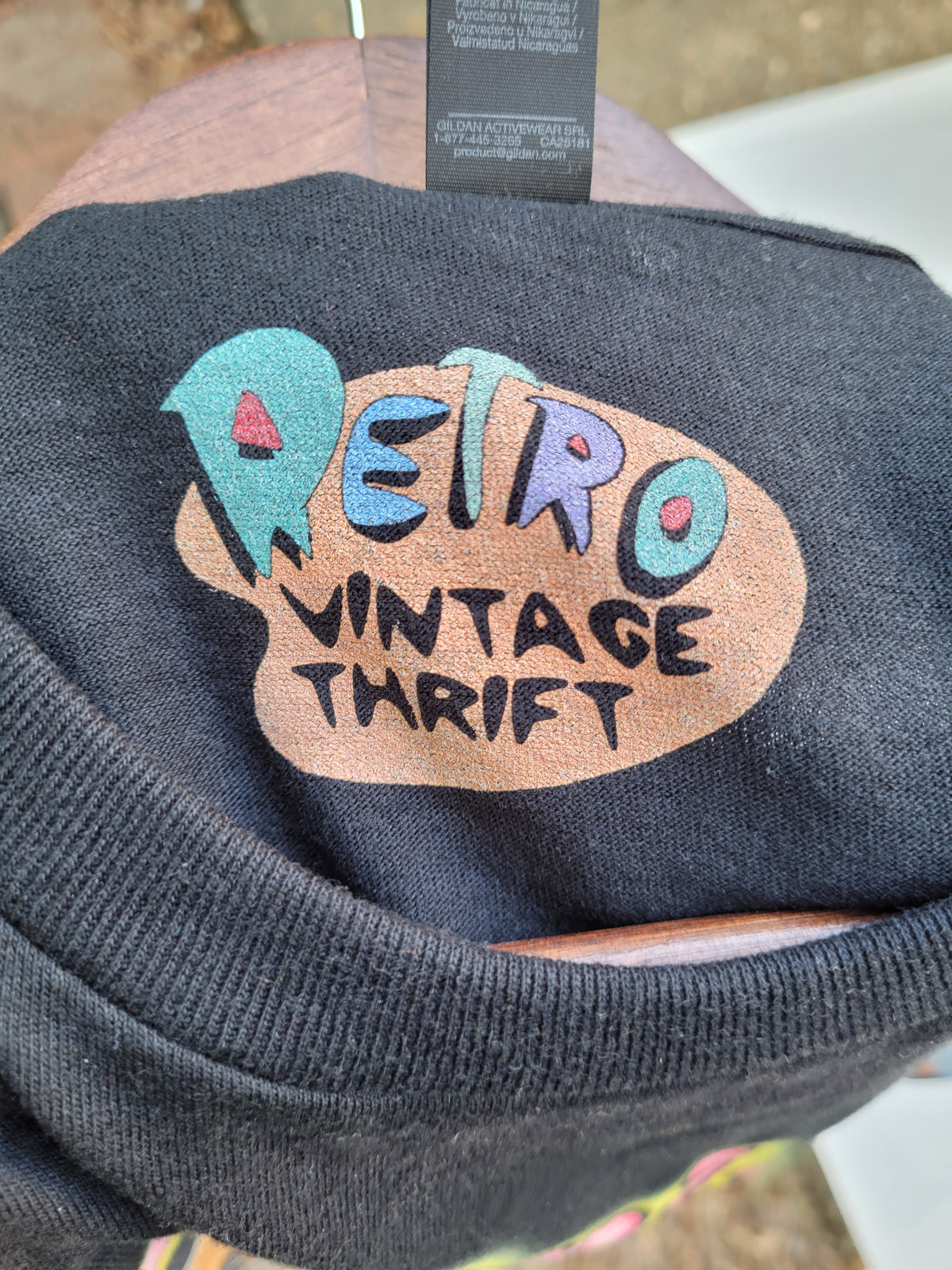 Black retro vintage thrift tee shirt collar detail from Black Owned Thrift with colorful lettering