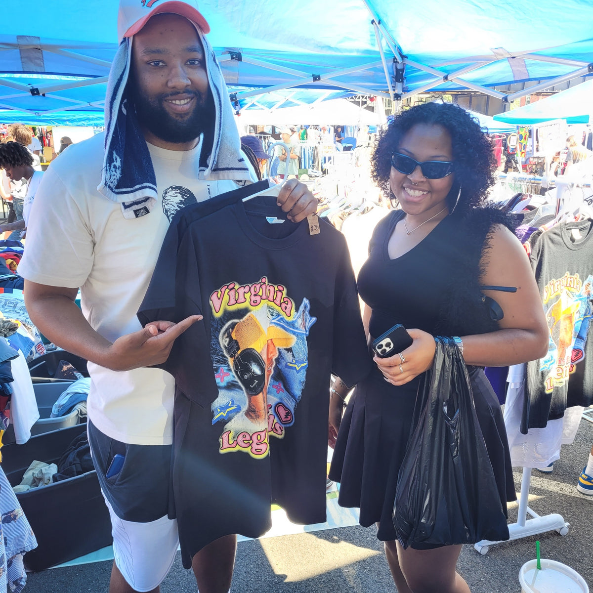 Man holding Virginia Is for Legends Y2k P tee with colorful graphic design at outdoor market