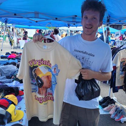 Man holding Virginia Is for Legends Y2k P tee with colorful vintage graphic at outdoor market