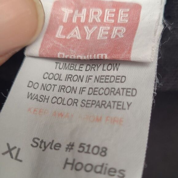 Care label on Y2K Slipknot Graphic Hoodie by RetroVintage Thrift with washing and ironing instructions